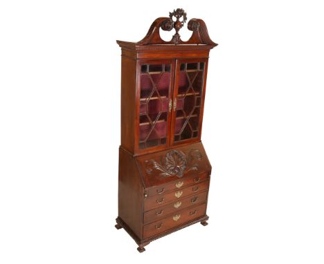 A Chippendale style mahogany bureau bookcase, the upper section with a bold swan-neck pediment with dentil moulding and finia