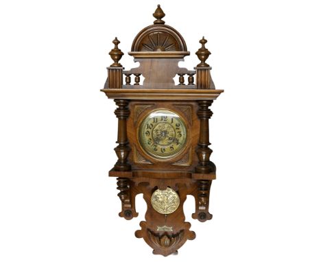 A 19th Century walnut wall clock of Vienna type, with two train movement striking a coil gong on the half hours, the dial wit