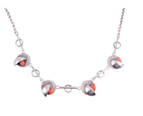 A coral necklace, circa 1920, formed of four abstract circular links set to the front with a domed half circle and a single c