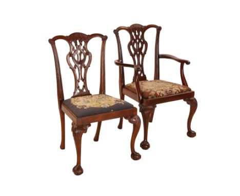 A set of eight Chippendale style mahogany dining chairs, including a pair of carvers, each with yoked crest rail above a pier