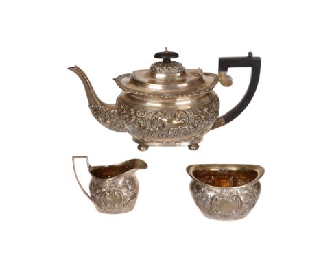 A matched silver three piece tea service, teapot, S. Blanckensee & Son Ltd, Birmingham 1917; each piece boldly chased with C-