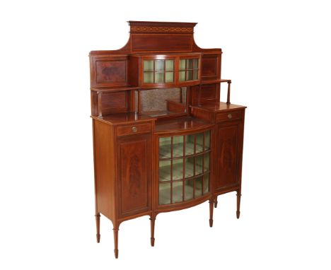 A late Victorian inlaid mahogany sideboard, the superstructure with dentil cornice over a pair of bow-front astragal glazed d