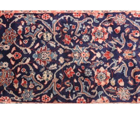 A Sarog runner, with a floral design against a blue ground. 370cm by 72cm