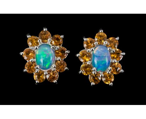 Opal and Yellow Sapphire Stud Earrings, each earring comprising an oval cut opal framed by nine round cut yellow sapphires, t