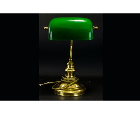 Bankers Lamp Comprising circular brass tone bass with traditional bottle green hinged glass shade. Height 14 inches. 