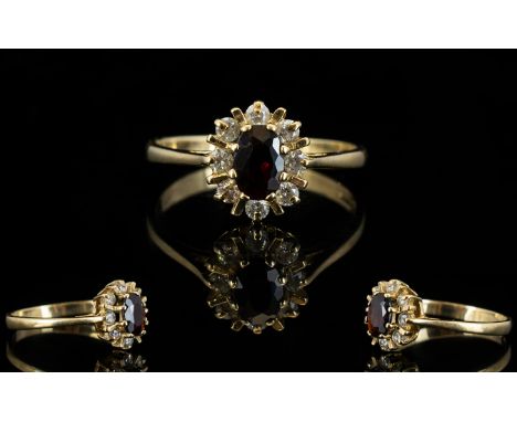Ladies 9ct Gold - Garnet and Diamond Cluster Ring, Flower head Design. The Central Ruby Surrounded by 10 Diamonds. Fully Hall