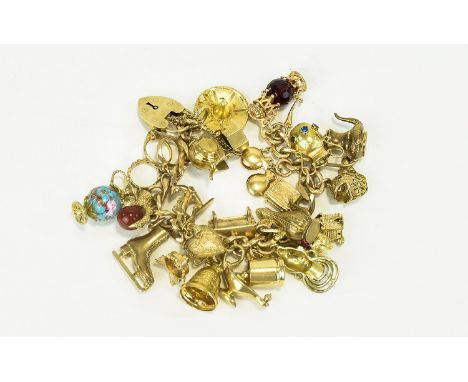 A Vintage and Heavy Wonderful 9ct Gold Bracelet loaded with 26 good quality 9ct gold charms. Fully hallmarked some interestin