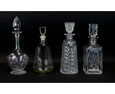 A Collection of Four Cut Glass Decanters to include footed specimen flask, square cut glass with star base etc . Please see a