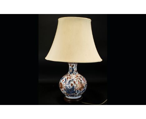 An Oriental Style Ceramic Table Lamp Of large proportions, the ceramic gourd shaped base finished in traditional cobalt and r