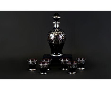 Glass Decanter And Shot Glasses Decorative decanter of specimen flask form in amethyst glass decorated with silver scroll det