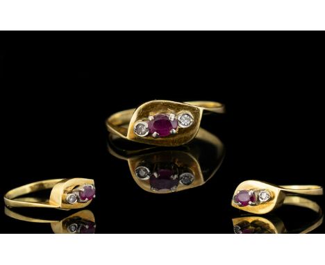 18ct Gold - Attractive Ruby and Diamond 3 Stone Dress Ring. The Central Ruby Flanked by Two Small Diamonds. Marked 750, Ring 