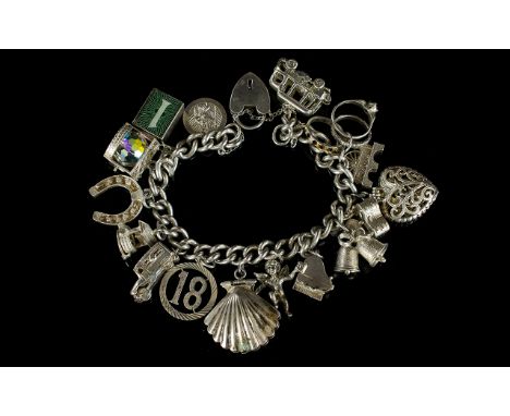 A Silver Curb Bracelet Loaded with 16 Good Quality Silver Charms. All Fully Marked for Silver. And All In Excellent Condition