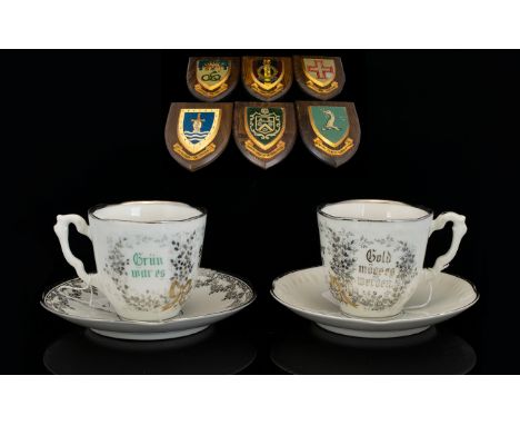 A Collection Of Six Oak Back Shield Crests Each bearing family coat of arms. Together with two K.P.M cups and saucers, white 