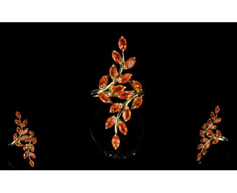 A 9ct Yellow Gold Brazillian Buriti Fire Opal Ring An unusual long foliate/vine design statement ring set with 16 faceted ova