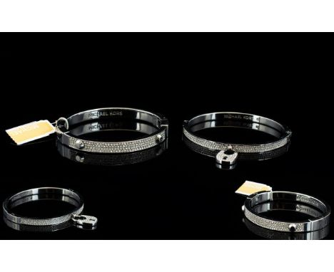 Michael Kors Two Silver Tone And Crystal Set Clasp Bangles Each with impressed 'MK' Michael Kors branding to inner band, comp