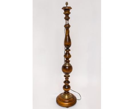 A Turned Sectional Standard Lamp Height 55 inches, raised on circular base with bun feet and brass tone sections