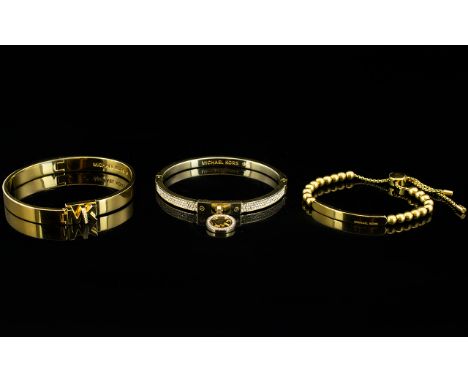 Michael Kors Three Gold Tone And Crystal Set Clasp Bangles Each in as new, unworn condition with 'MK Michael Kors' branding t