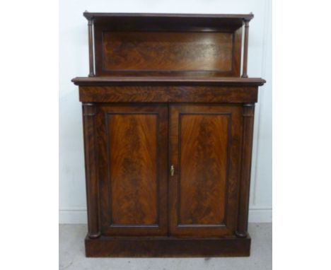 A late Victorian mahogany chiffonier, having a gilt metal galleried shelf, over a panelled back with turned supports, above a