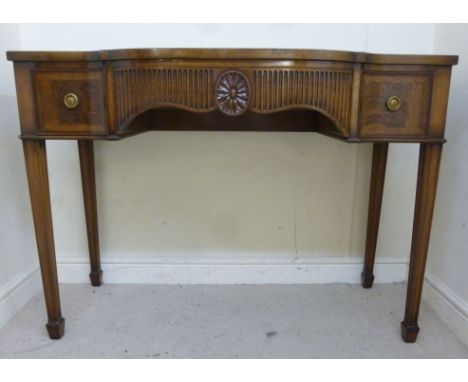 A modern Hillie bow front serving table, having a central drawer, flanked by two short drawers, raised on square, tapered leg