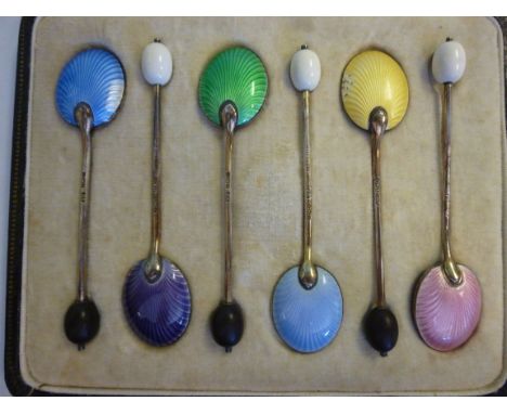 A set of six silver coffee spoons with alternating white and black bean terminals and engine turned enamelled back bowls  Bir