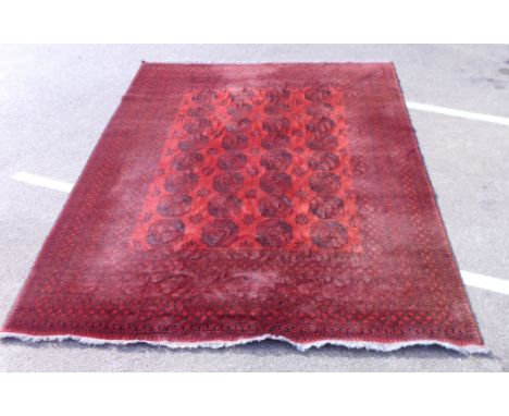 A Pakistan Turkoman carpet with three columns of guls on a red ground  121'' x 80''