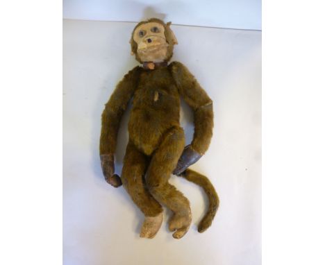 A 1930s (possibly Steiff) brown mohair toy monkey with a moulded felt face and glass eyes  16''h