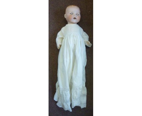 An early 20thC Armand Marseille bisque head doll, having painted features and weighted sleeping eyes, on a jointed compositio