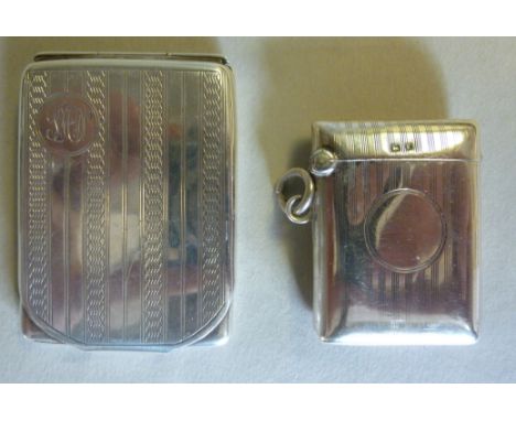 An early 20thC silver vesta case with a hinged lid and engine turned decoration  Birmingham 1915; and a similar silver bookma