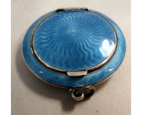 A 1920s silver powder compact, decorated with engine turned turquoise enamel, the hinged lid set with an internal mirror  Ale
