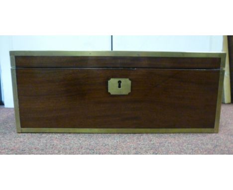 A late Victorian mahogany military design writing slope with brass bound edges and opposing recessed handles, enclosing a too