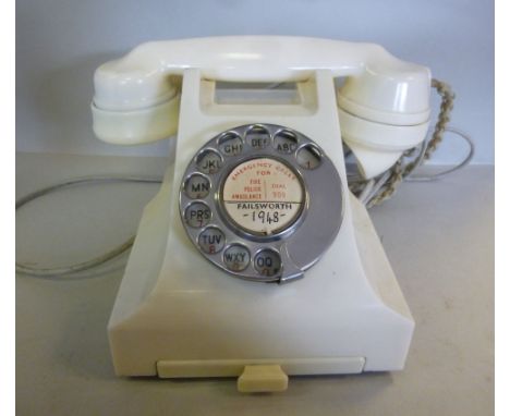 A vintage white Bakelite cased telephone handset with a base drawer, bearing a recessed stamp 16455