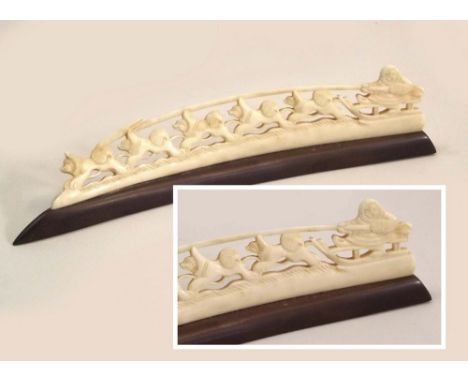 INUIT CARVING. An Inuit Pacific North West carved walrus ivory &amp; baleen dog sled, with Inuit driver. Length 17cm.