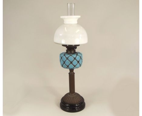 OIL LAMP. A Victorian oil lamp with opaque blue glass fount. Height 69cm. PLEASE NOTE: Our in-house, postal shipping service 