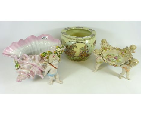 Large porcelain shell shaped flower encrusted dish supported by three Cherubs, another similar centre piece and Satsuma plant