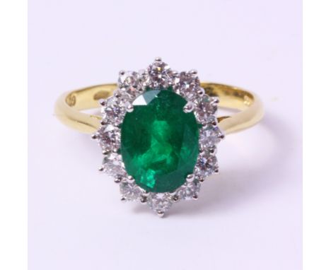 Gold emerald and brilliant cut diamond cluster ring, oval cut stone of 1.82 carats hallmarked 18ct   Condition Report   Click