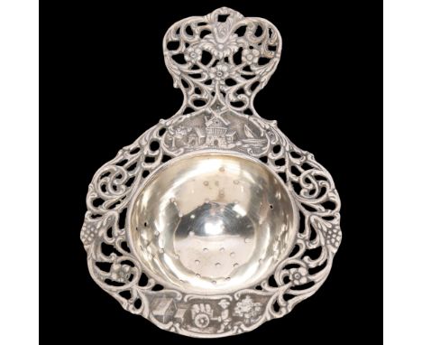 A Swedish silver tea strainer, with relief embossed windmill decoration and pierced floral border, 12.5cm, 1.5oz . Condition 