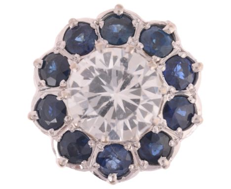An 18ct gold blue and white sapphire flowerhead cluster ring, maker JM Co, London 1979, setting height 15.5mm, size N, 6.9g .