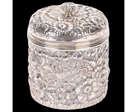 TIFFANY & CO - an American sterling silver dressing table powder jar and cover, cylindrical form with relief embossed floral 