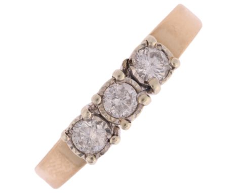 A 9ct gold three stone diamond ring, maker TAD, illusion set with modern round brilliant-cut diamonds, total diamond content 