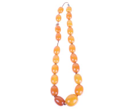 A single-row graduated amber bead necklace, beads measure: 29.0 - 17.5mm, 50cm, 82g . Condition Report:Necklace appears to be