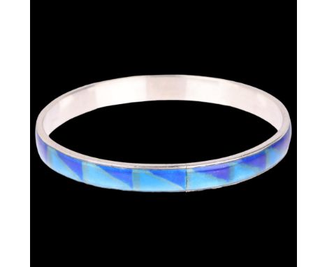 A Continental silver and blue enamel slave bangle, unmarked and tests as silver, band width 8.1mm, internal circumference 20c