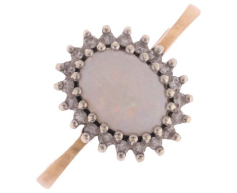 A 9ct gold opal and diamond oval cluster ring, setting height 12.2mm, size R, 2.6g . Condition Report:No damage or repair, al
