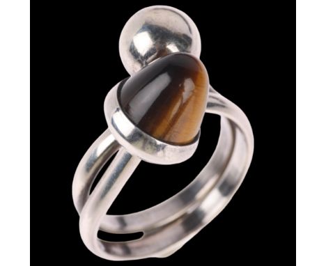 NIELS ERIK FROM - a Danish modernist sterling silver tigers eye crossover ring, setting height 16.5mm, size M, 5.9g . Conditi