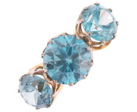An 18ct gold three stone blue zircon ring, claw set with round-cut zircons, setting height 10.5mm, size M, 6.4g . Condition R
