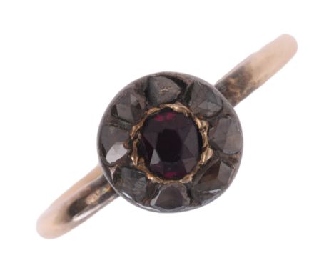 An Antique ruby and diamond cluster ring, set with oval mixed-cut ruby surrounded by Dutch rose-cut diamonds, apparently unma