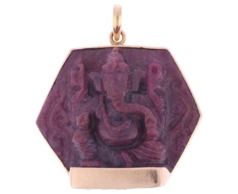 A large Eastern 14ct gold ruby Hindu God Ganesha pendant, set with carved and polished hexagonal ruby crystal, unmarked mount