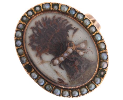 A Georgian hairwork and split pearl mourning ring, circa 1780, the central applied hairwork panel depicting wheatsheaf with s
