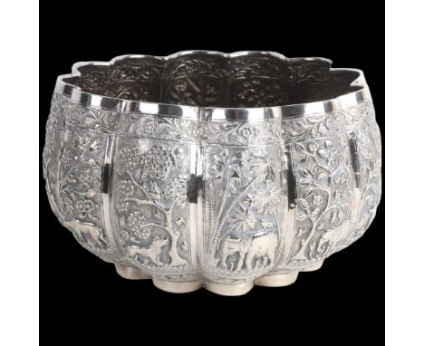 A fine quality Burmese silver Thabeik lobed rice bowl, early 20th century, with panels relief embossed depicting animals and 
