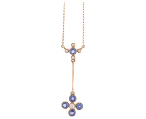 An Edwardian 15ct gold sapphire and split pearl drop pendant necklace, circa 1905, millegrain set with round-cut sapphires on