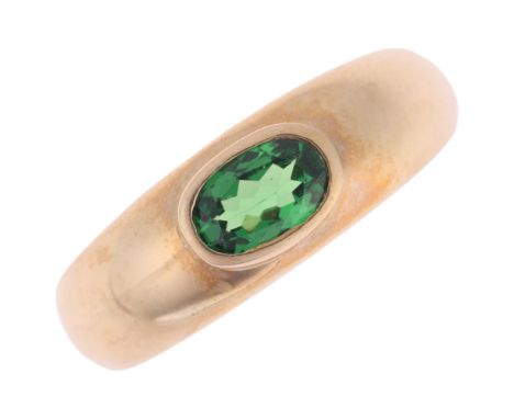 A 9ct gold tsavorite green garnet bombe ring, rub-over set with oval mixed-cut garnet, setting height 6.3mm, size K, 3.7g . C